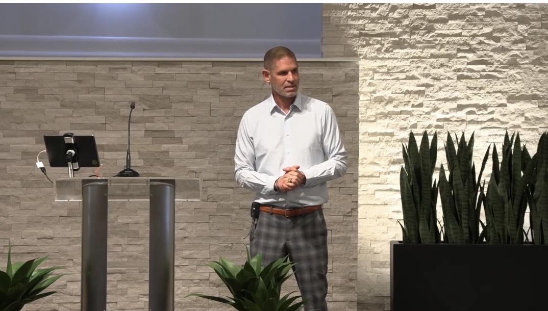 Dane Boyles preaching in a church