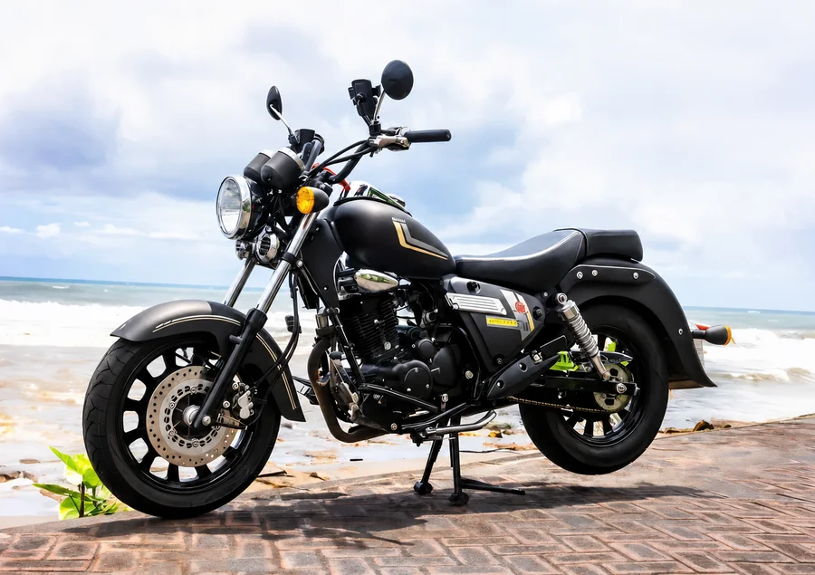 Black-and-chrome Benelli Motobi 200 Evo cruiser with round headlamp, low bench seat, long exhausts and side bags