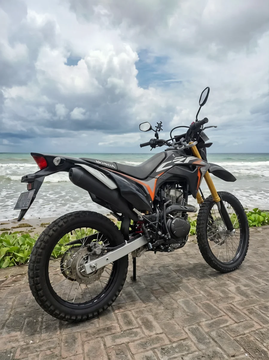 Red Honda CRF150L lightweight dual-sport motorcycle with tall suspension, spoked wheels and trail-oriented tyres