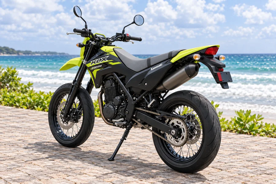 Neon-green and black Kawasaki KLX230 Supermoto, front-left view, beside the ocean