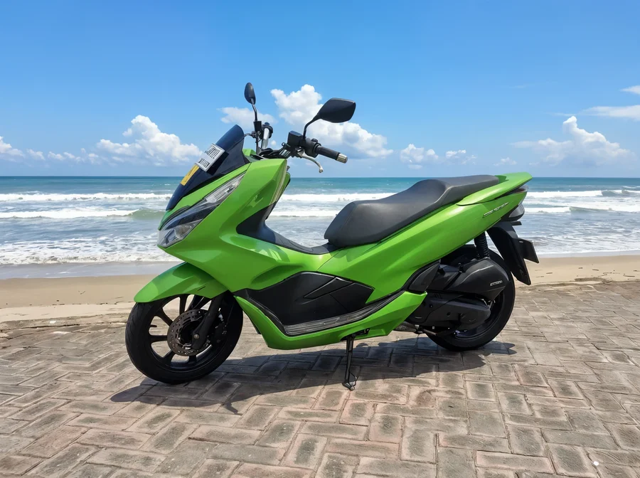 Bright green Honda PCX150 automatic road scooter with integrated windscreen and broad stepped seat
