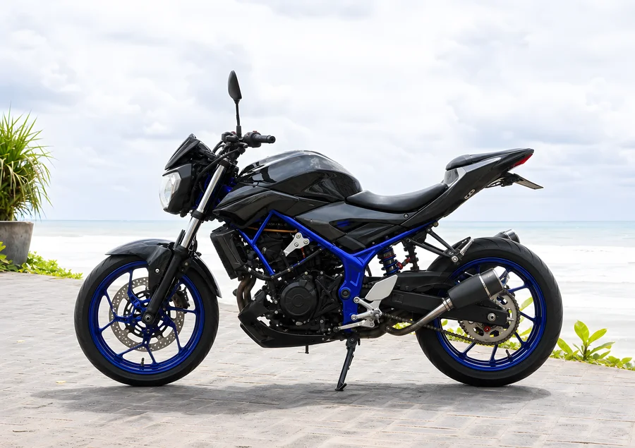 Black and blue Yamaha MT-25 V1 upright 250cc naked motorcycle with exposed parallel-twin engine